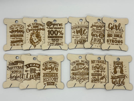 Set of wooden tags with motivational phrases on a white background