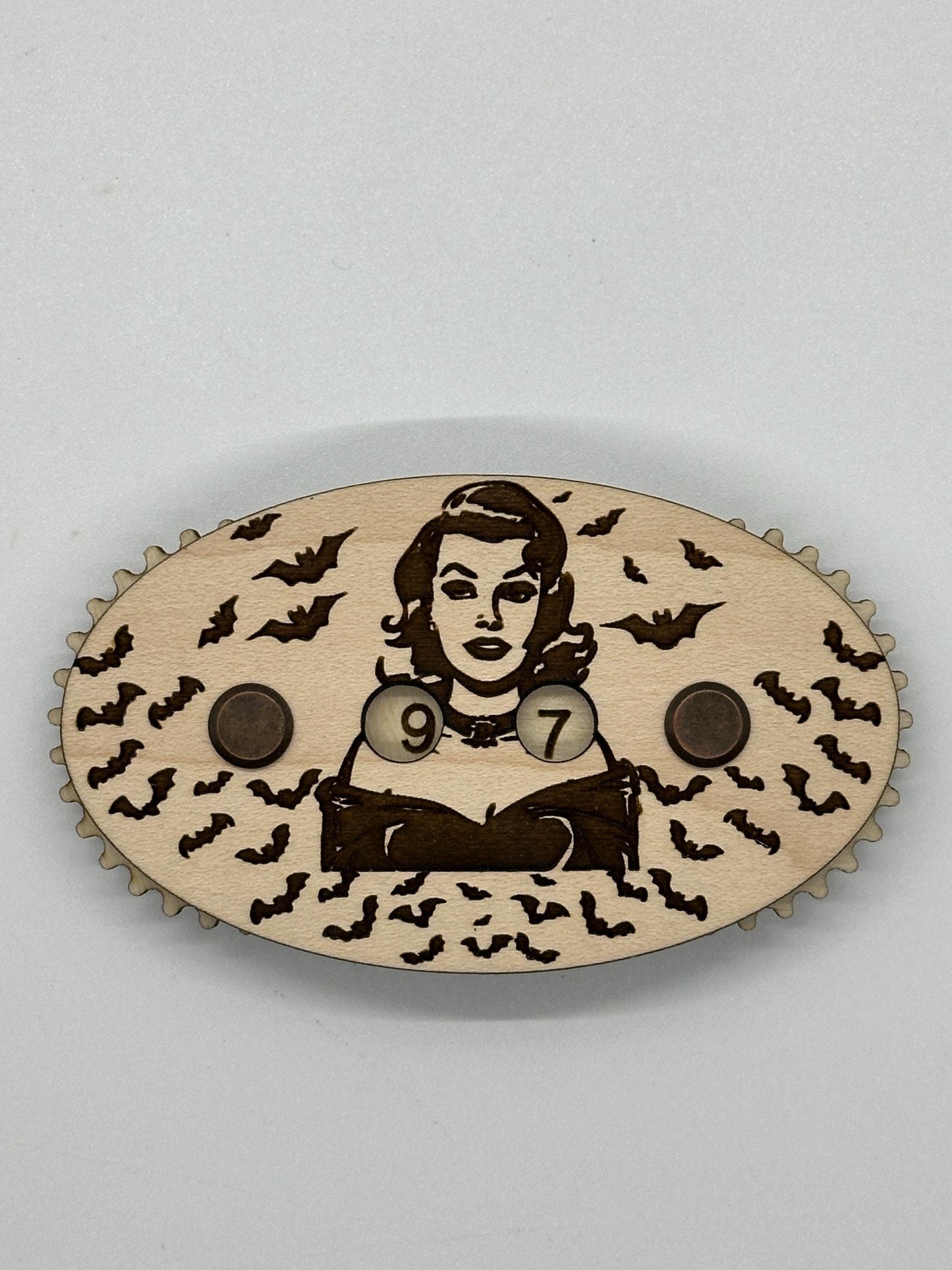 Wooden counter with a design of a woman, numbers, and bats on a light gray background