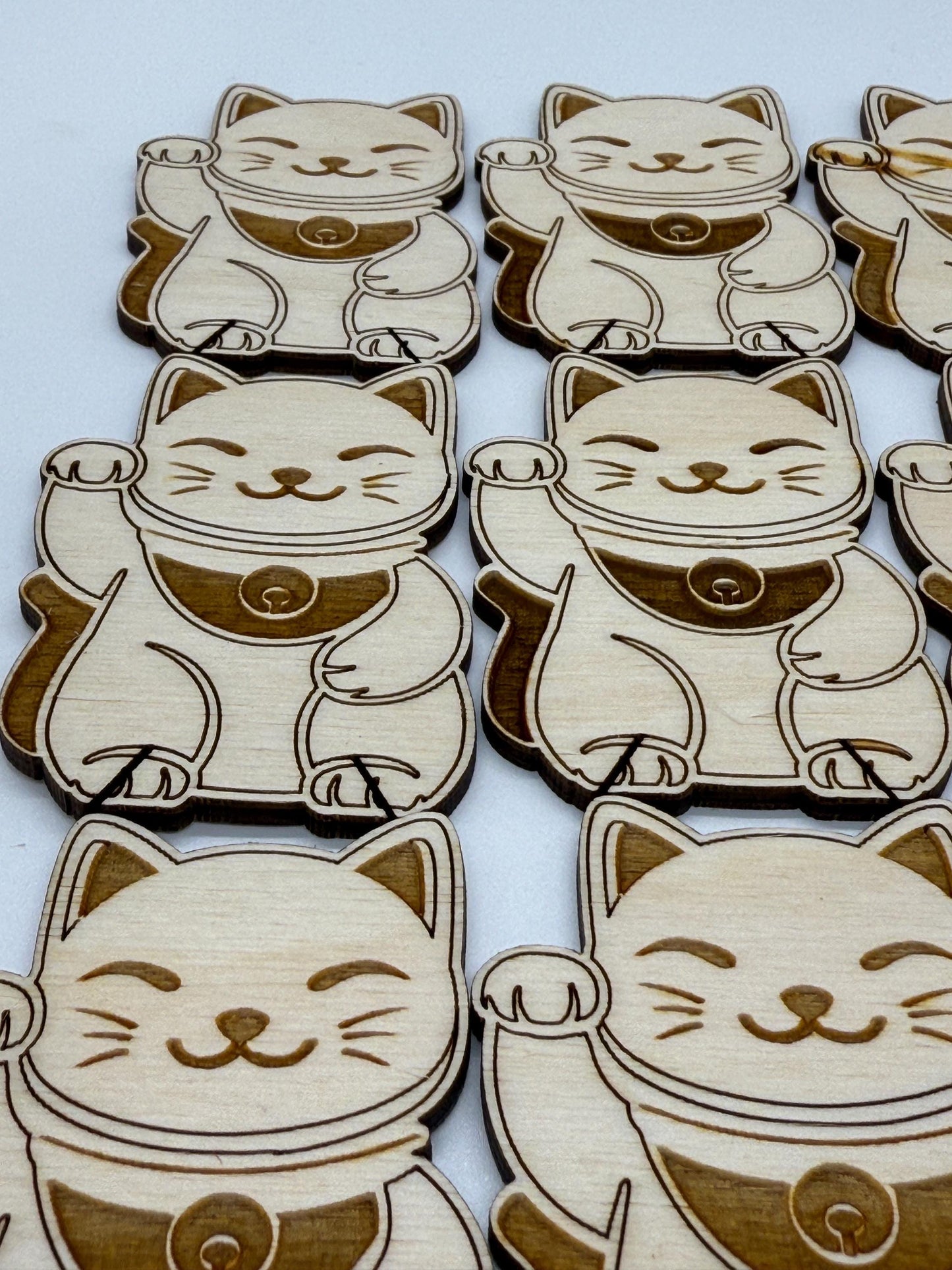Wooden lucky cat figurines on a white background