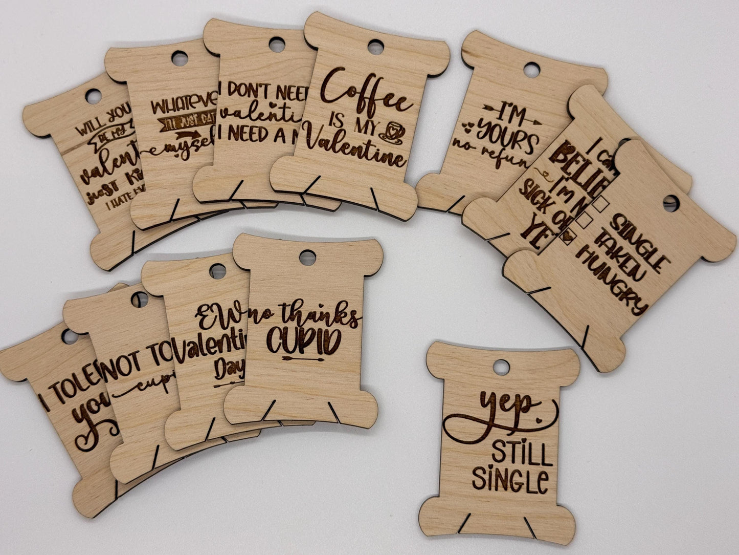 Wooden tags with humorous sayings on a white background
