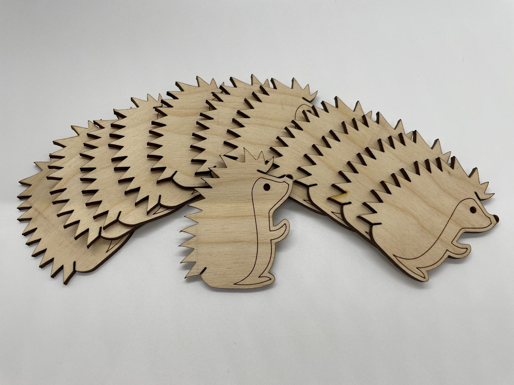 Wooden hedgehog cutout on a light gray background