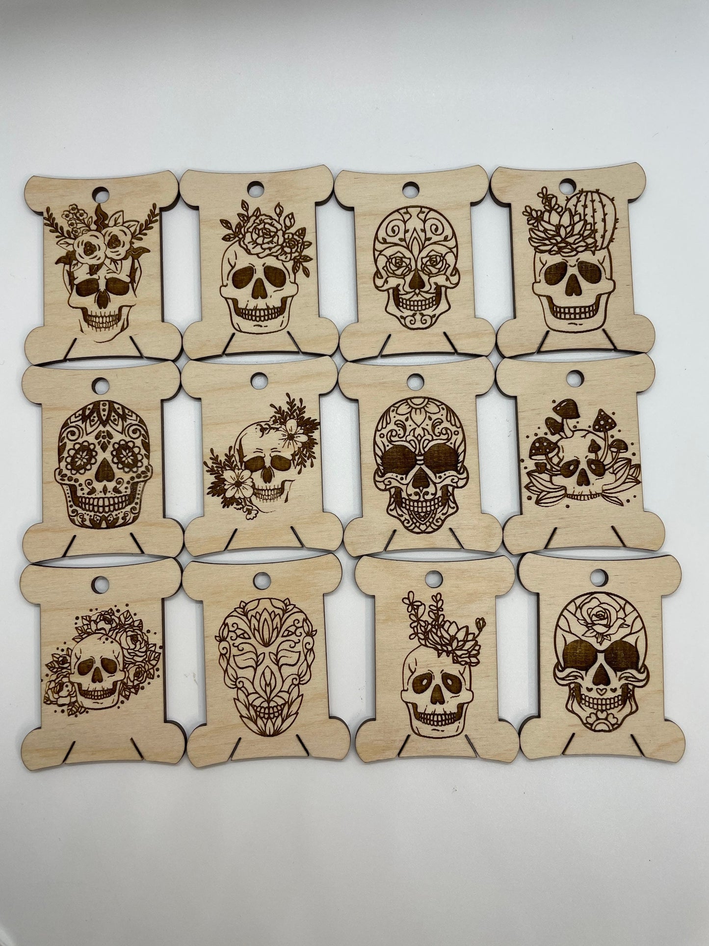 Set of wooden tags with skull designs on a white background