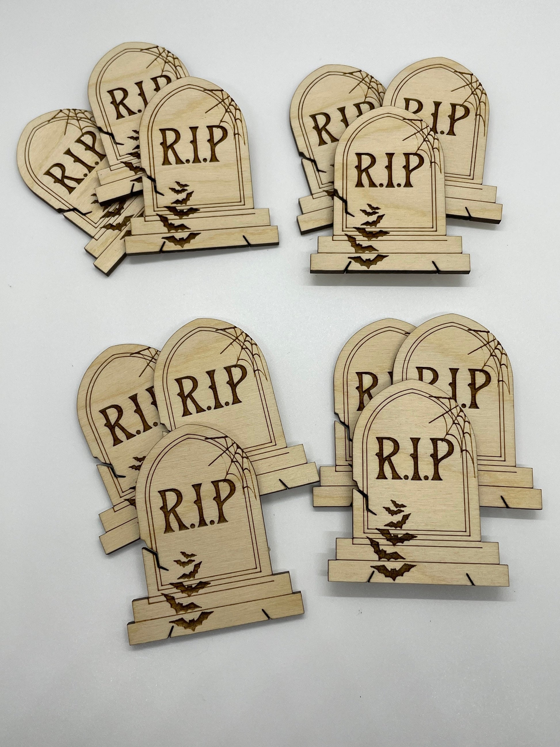 Set of wooden tombstone decorations with 'R.I.P.' text on a white background