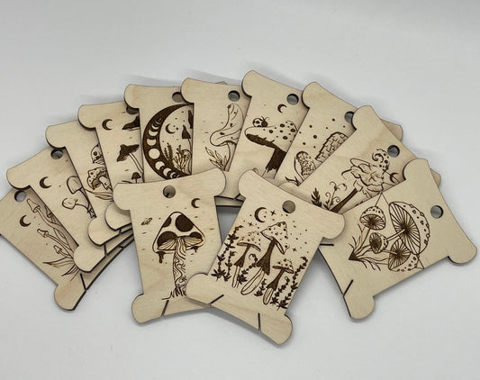 Set of wooden tags with engraved designs on a light gray background
