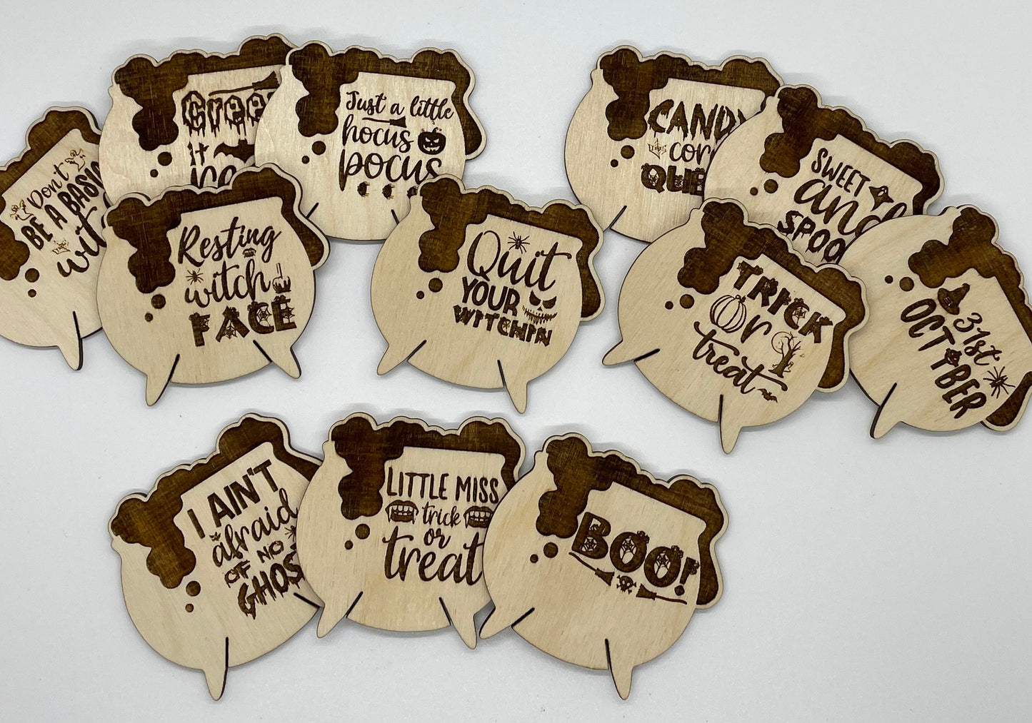 Set of Halloween-themed wooden cutouts with text on a white background
