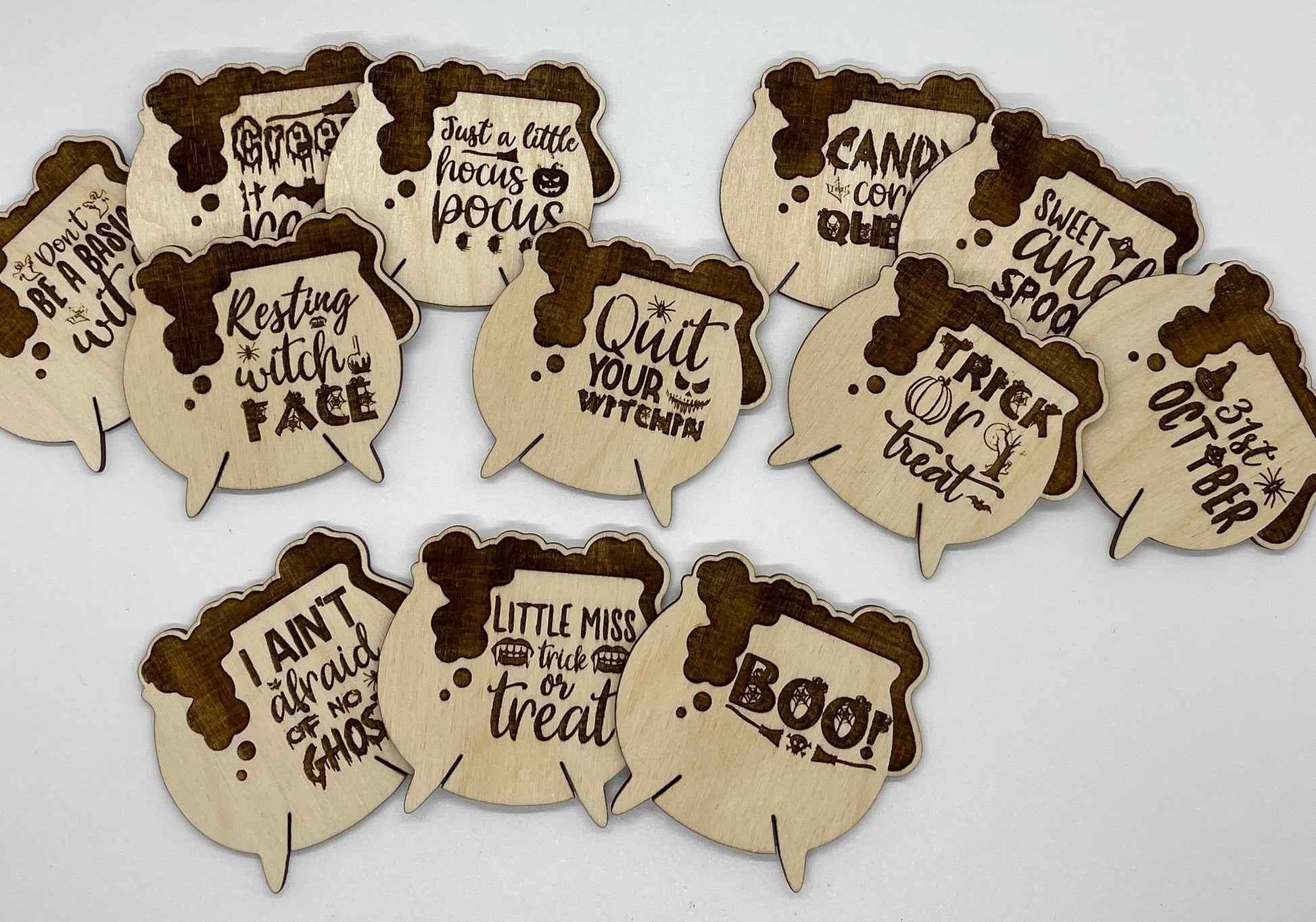 Set of Halloween-themed wooden cutouts with text on a white background