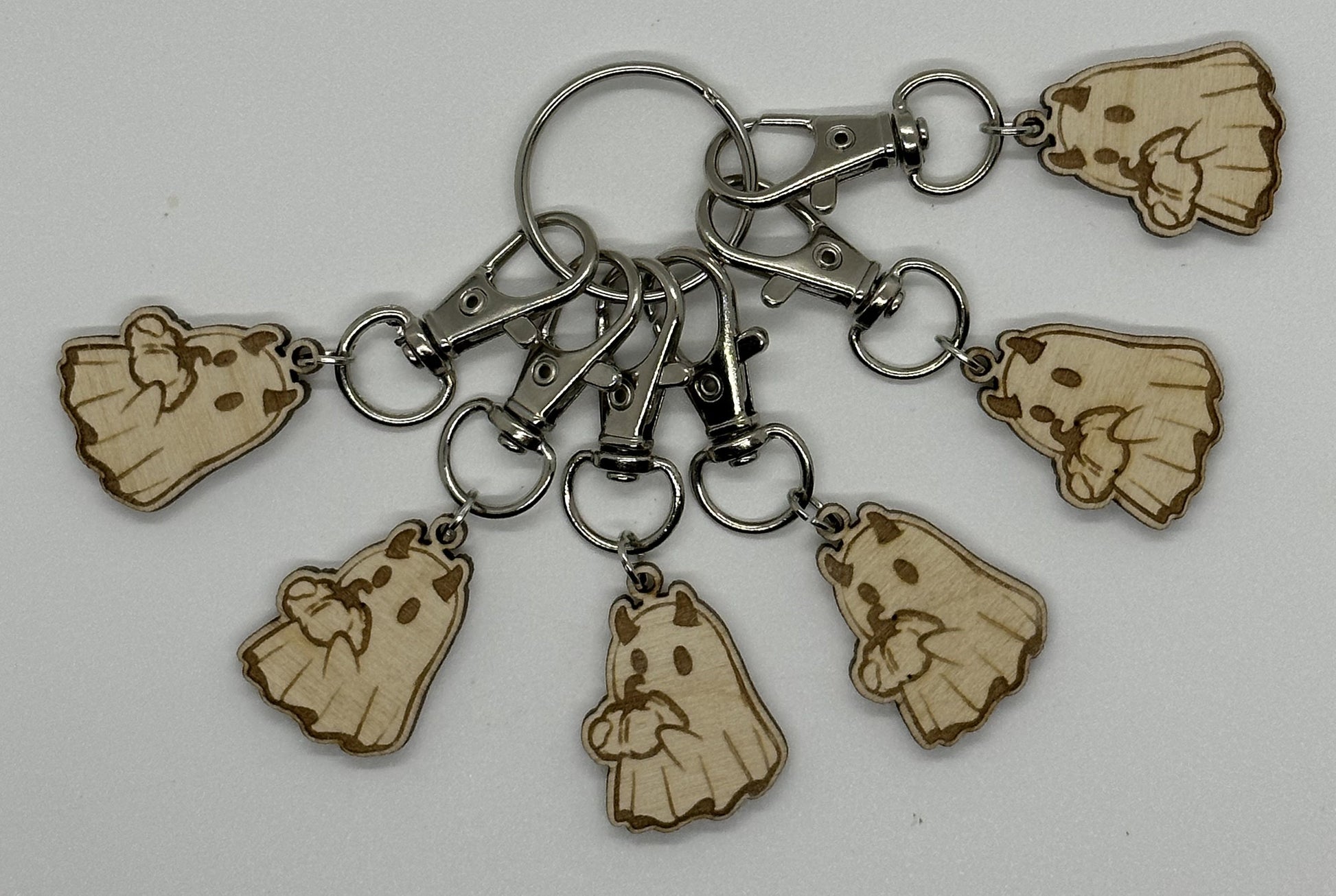 Keychain with wooden ghost charms on a white background
