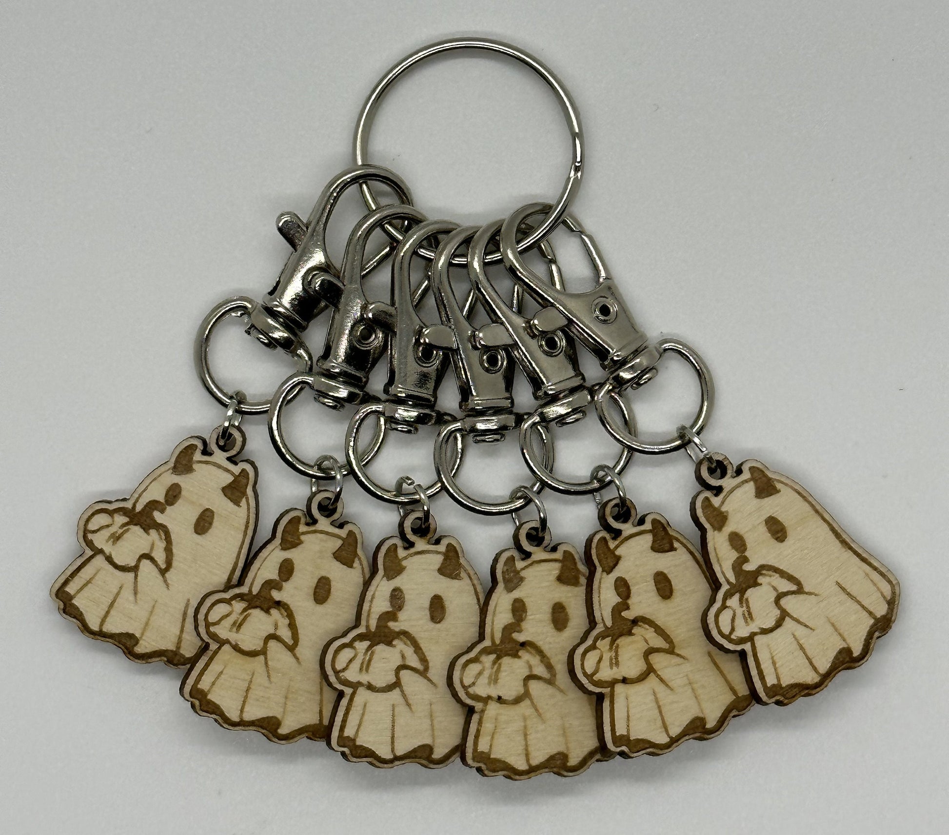 Keychain with wooden ghost charms on a white background