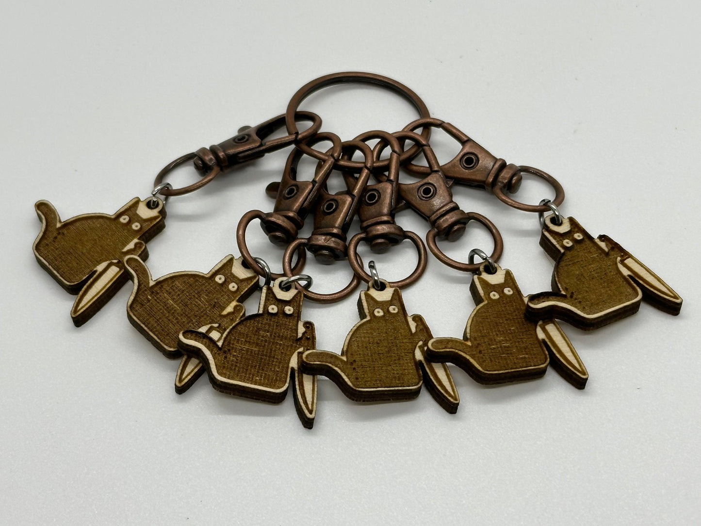 Bronze keychain with multiple cat charms on a white background