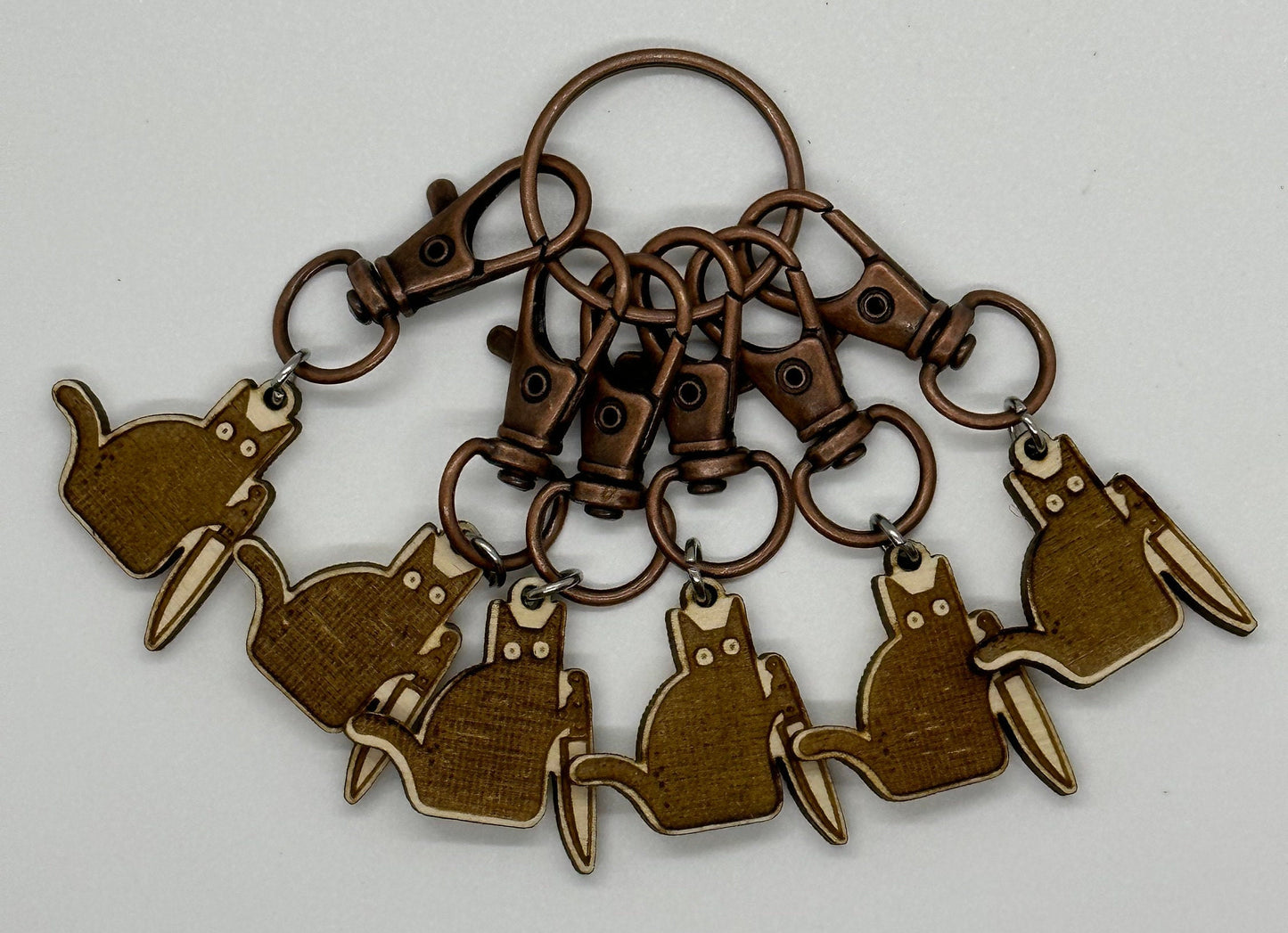 engraved keychain with multiple cat-shaped charms on a white background