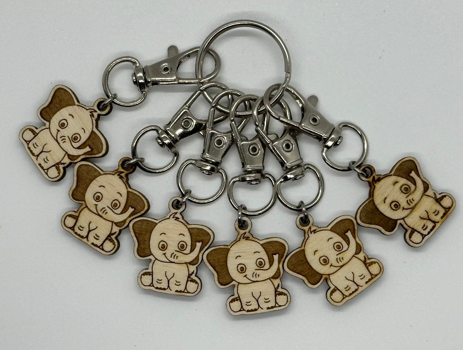 Keychain with multiple small elephant charms on a white background