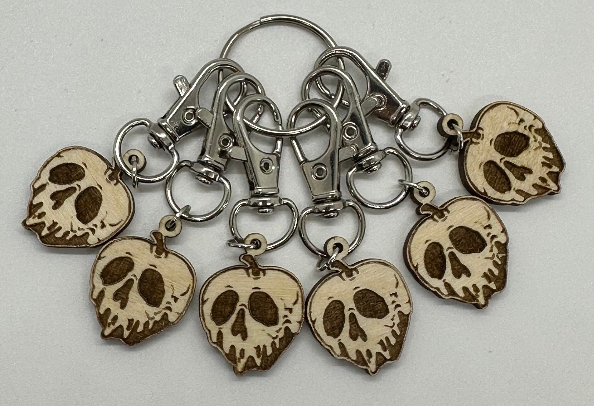 Set of skull-shaped keychains on a gray background