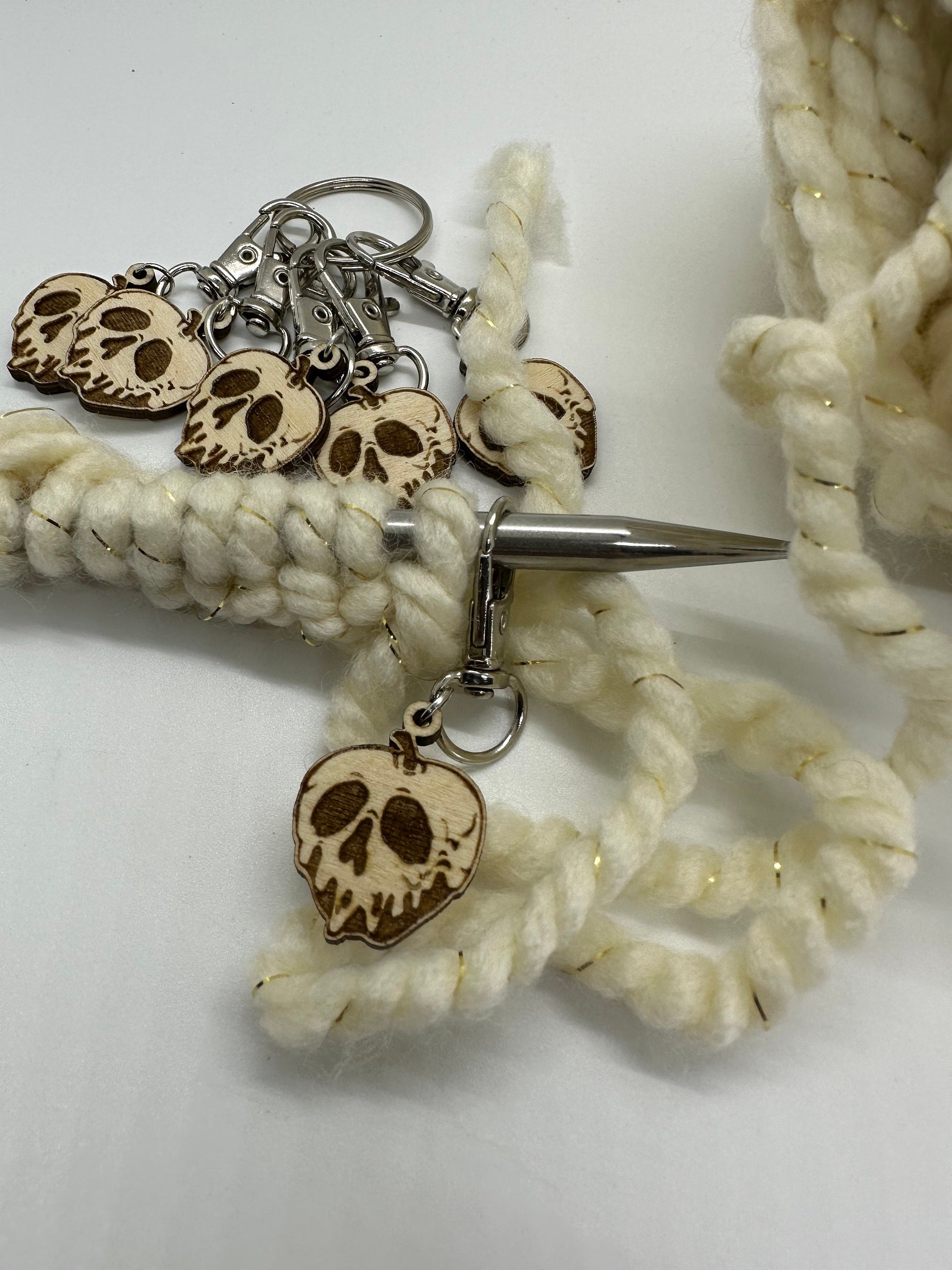 Close-up of a keychain with skull charms on a white background