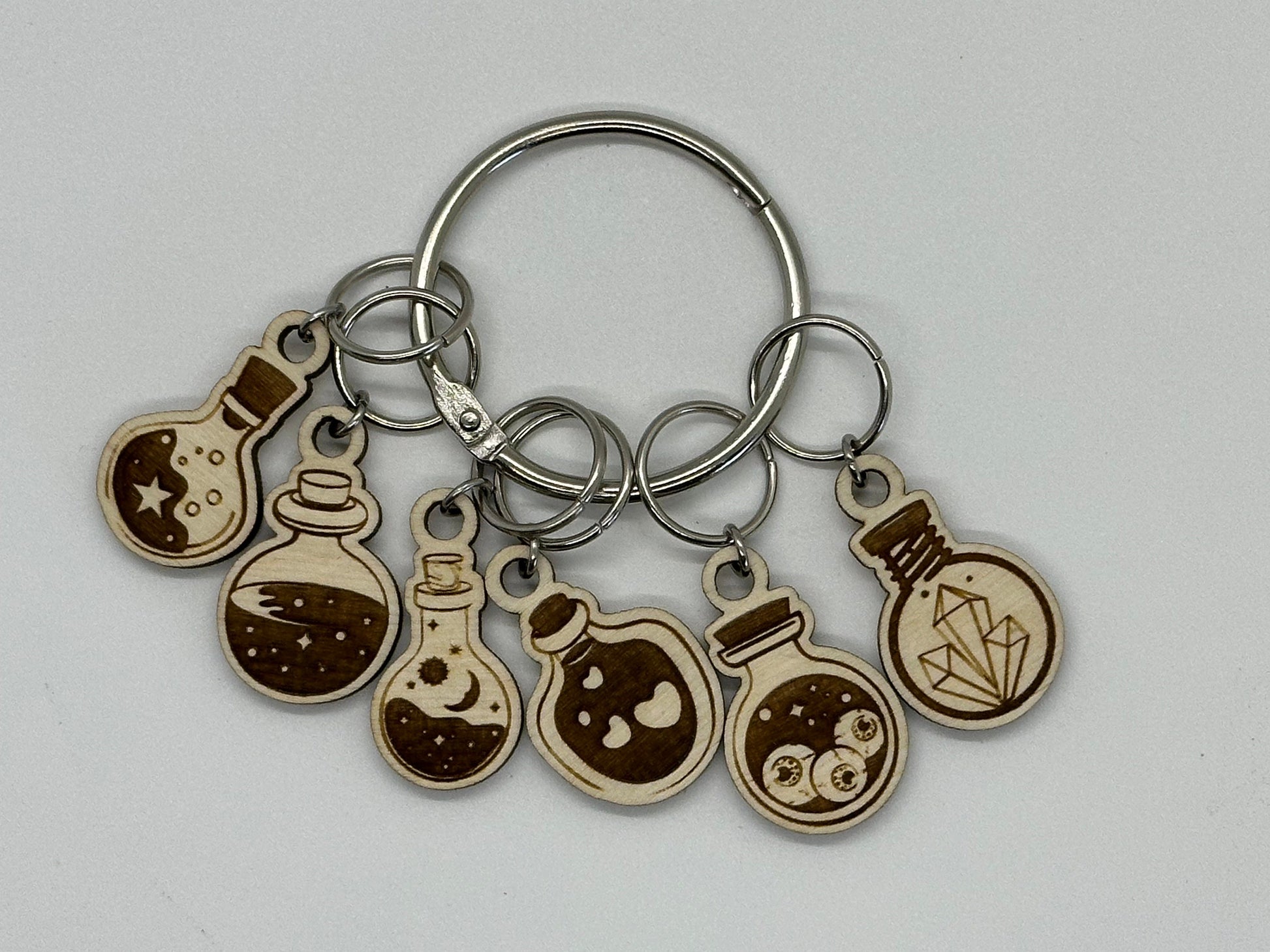 Keychain with various round charms on a gray background