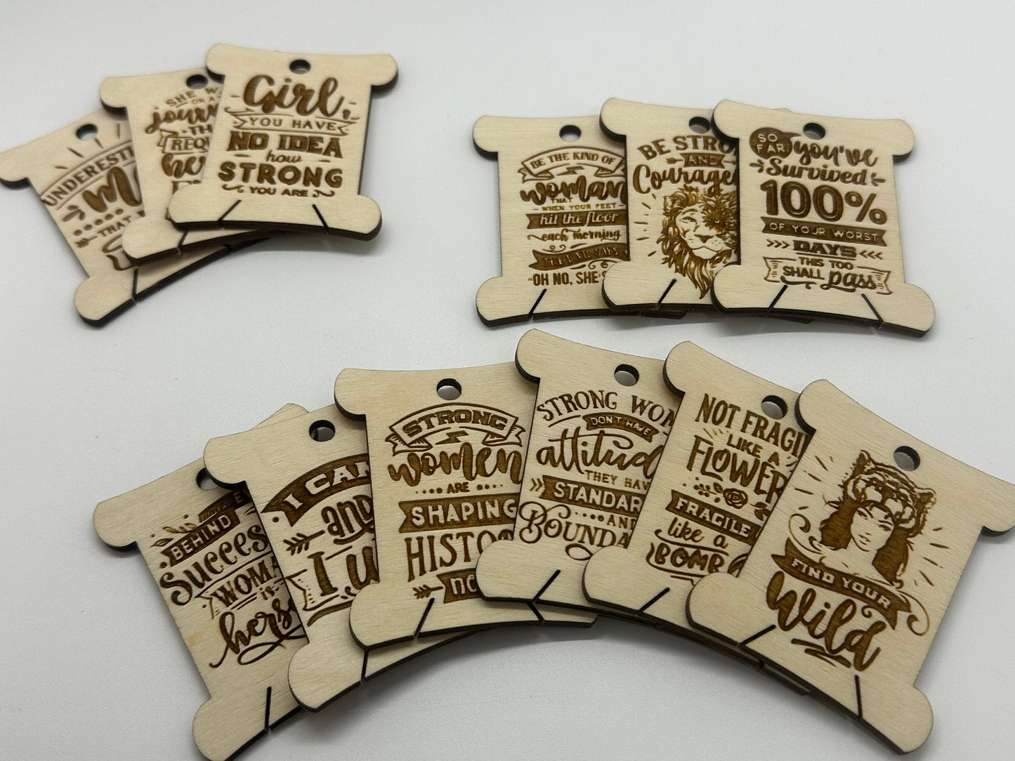 Wooden tags with motivational phrases on a white background