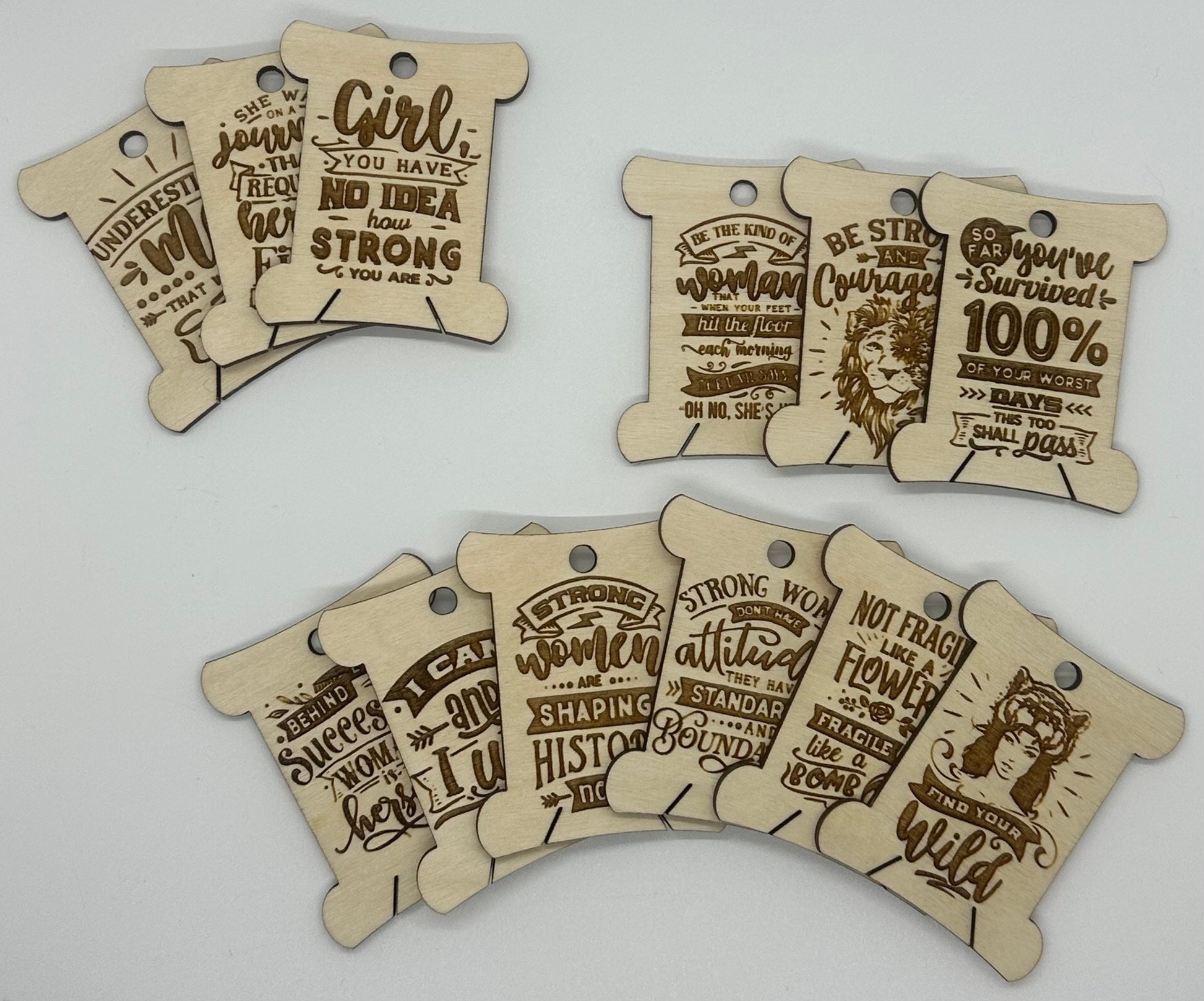 Wooden tags with motivational phrases on a light gray background