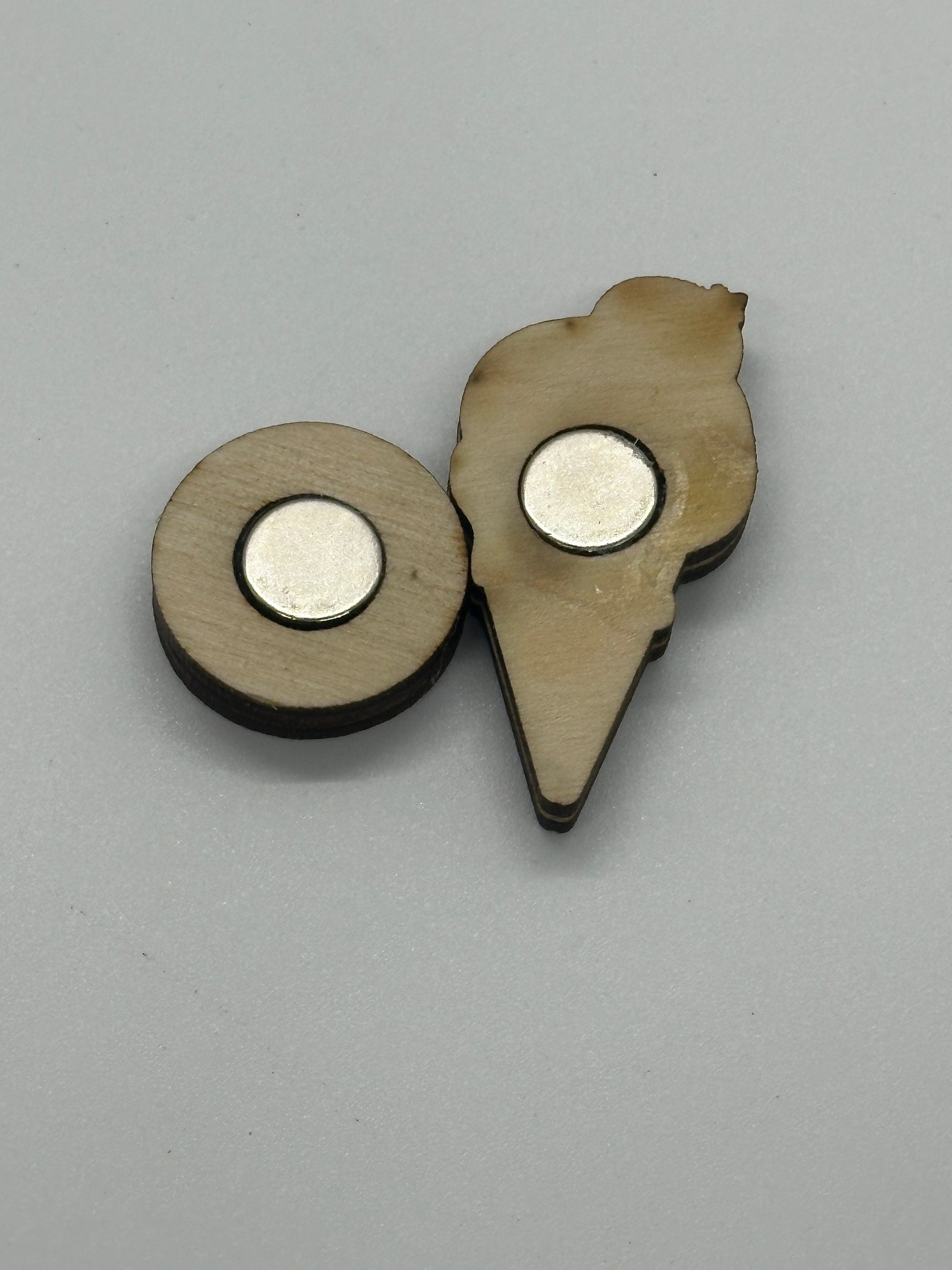 back piece with metal disc on a gray background