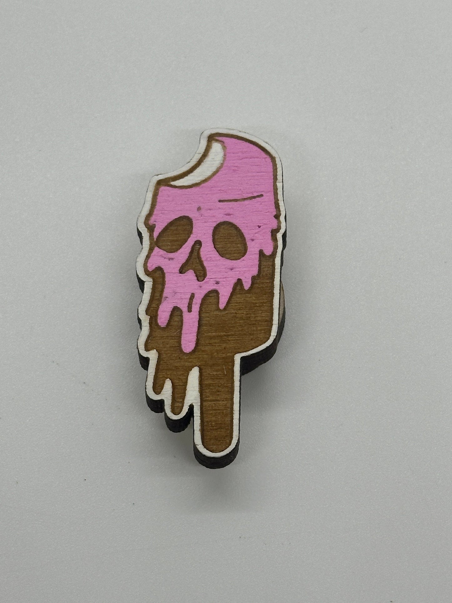 Ice cream cone with pink and brown design on a gray background