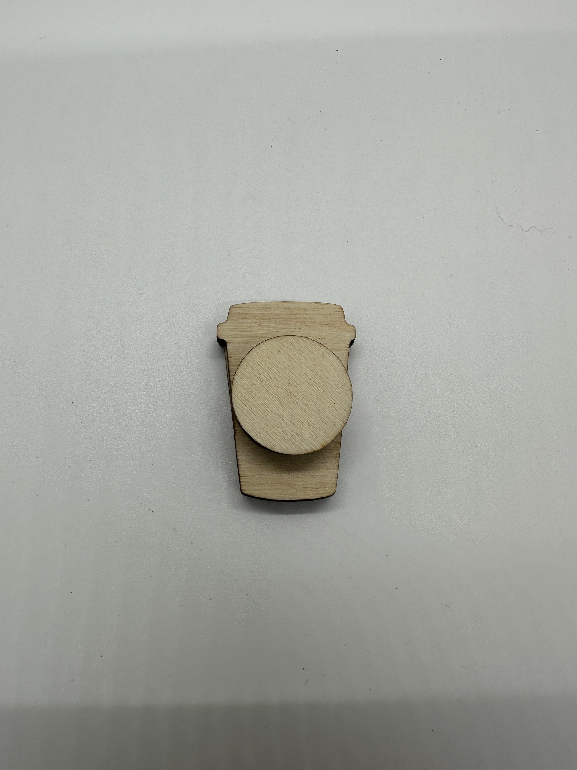 Wooden cutout of a coffee cup on a white background