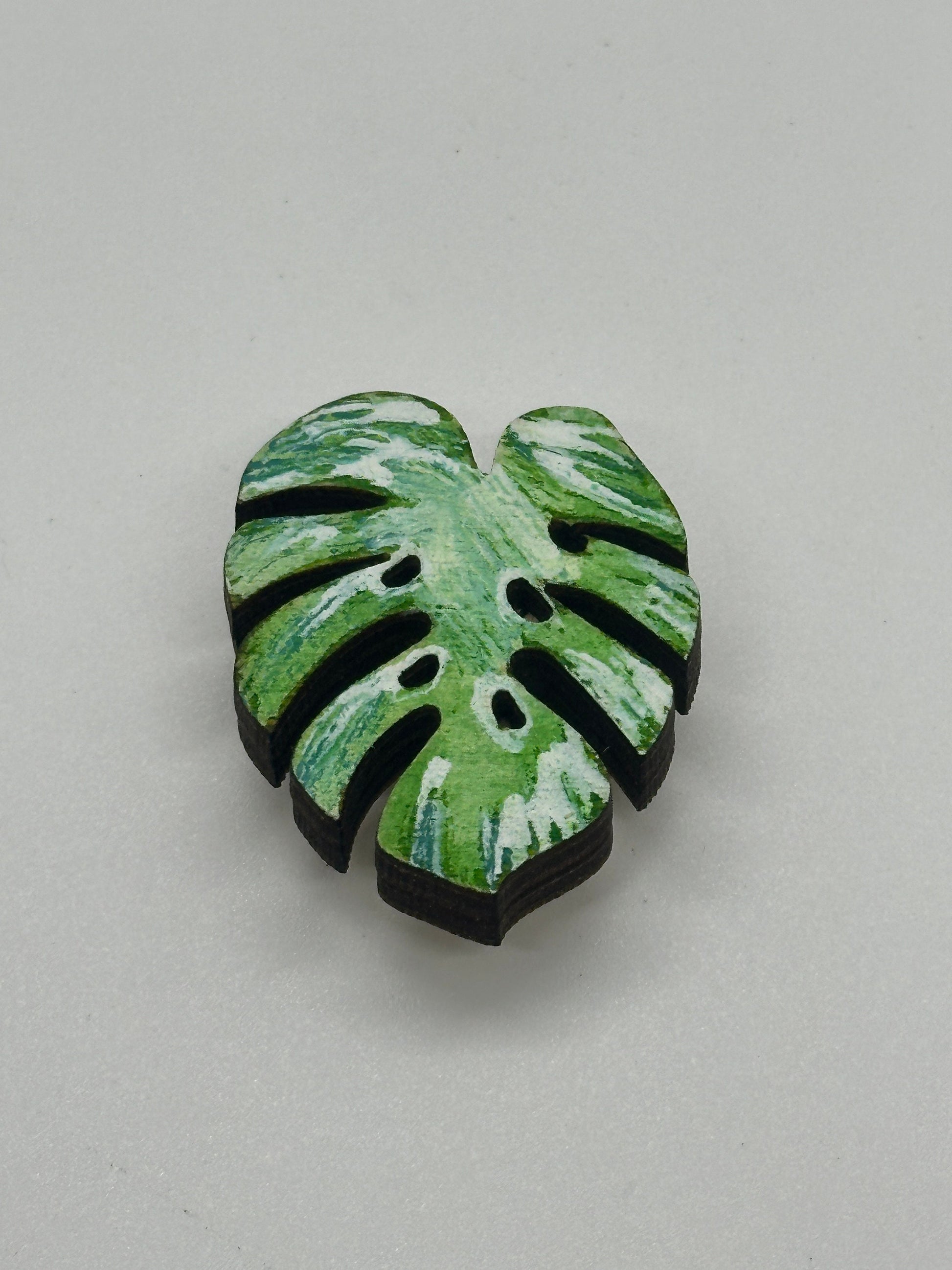 Green leaf-shaped object on a gray background