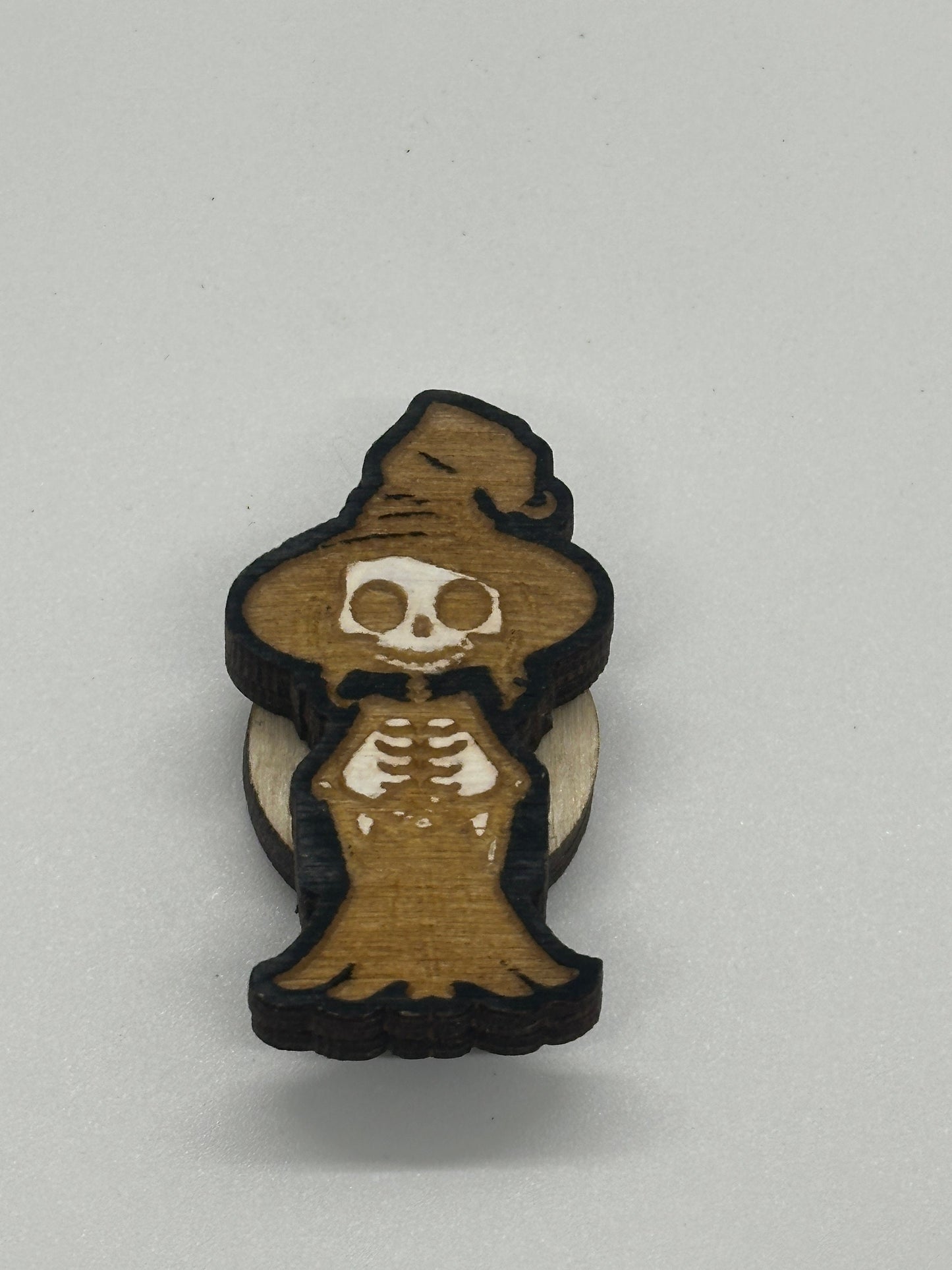 Wooden skeleton figurine with a hat on a white background