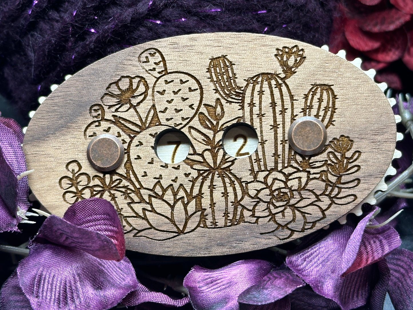 Wooden counter with cactus design on a purple fabric background