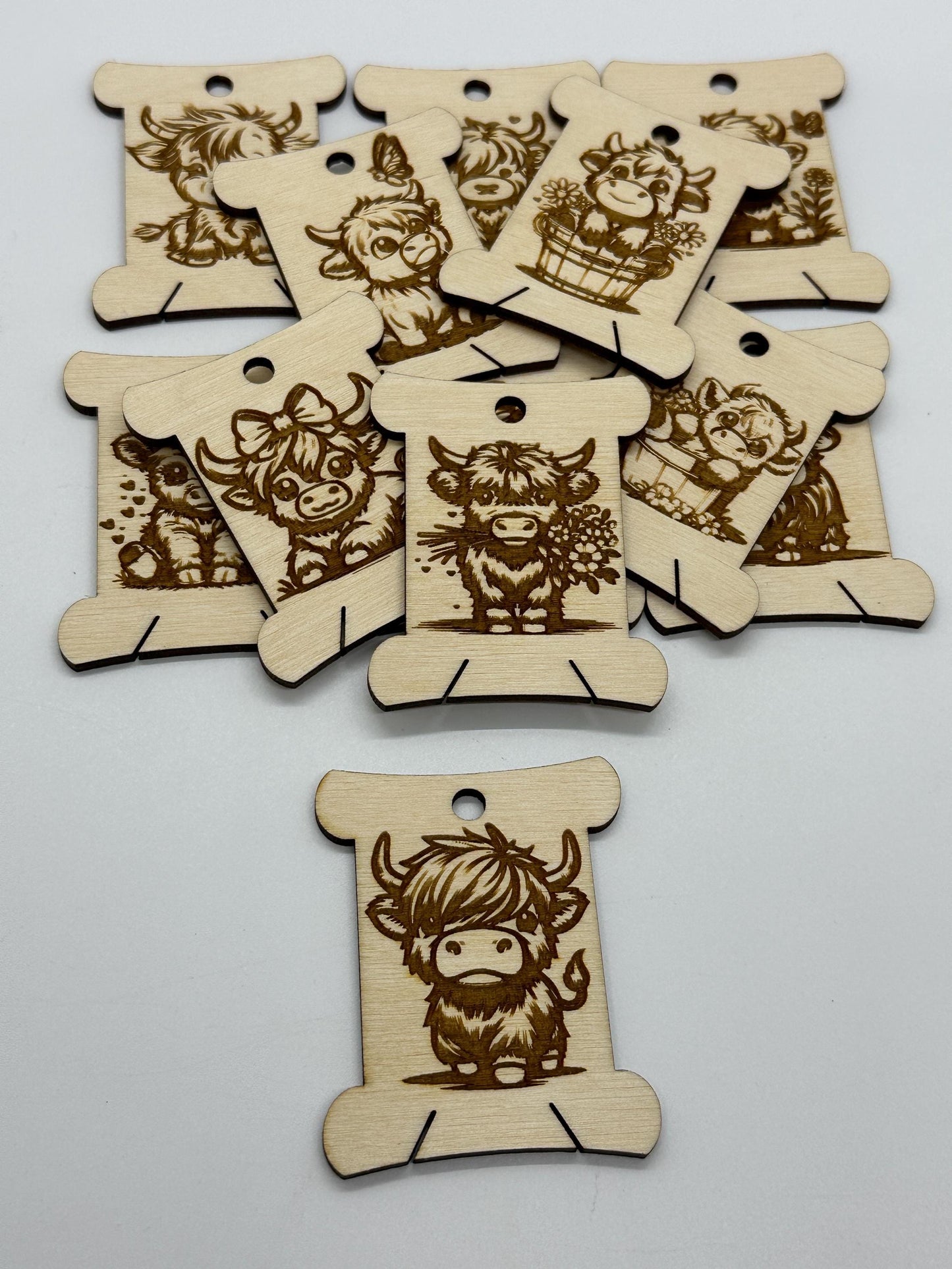 Wooden tags with engraved designs of cartoon characters on a white background