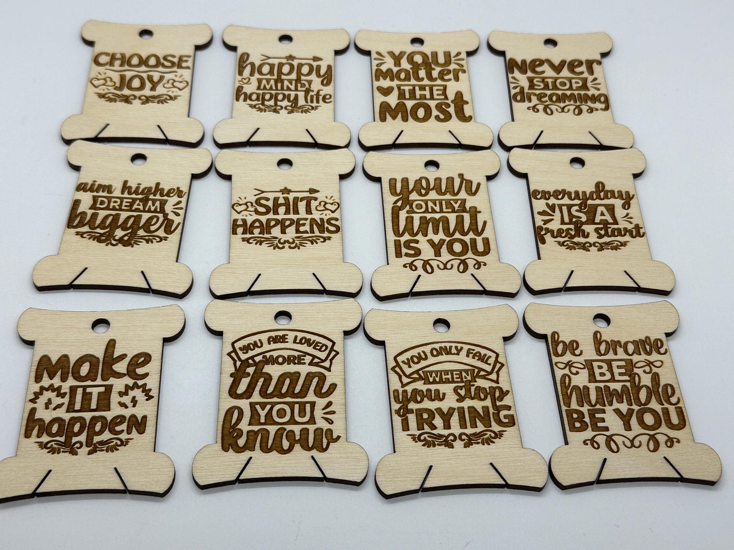 Set of wooden motivational tags with engraved quotes on a white background
