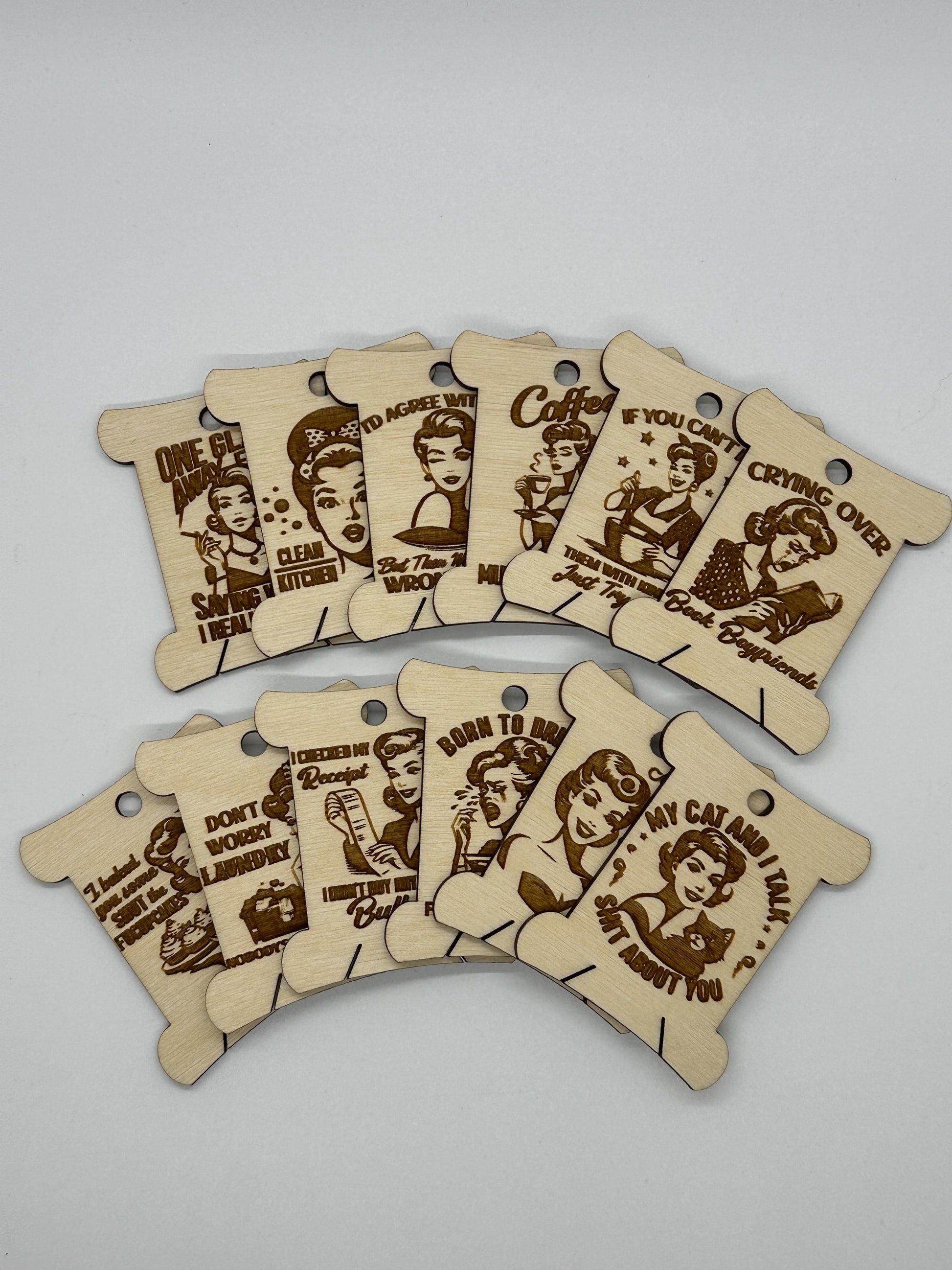 Set of wooden tags with engraved text and illustrations on a gray background