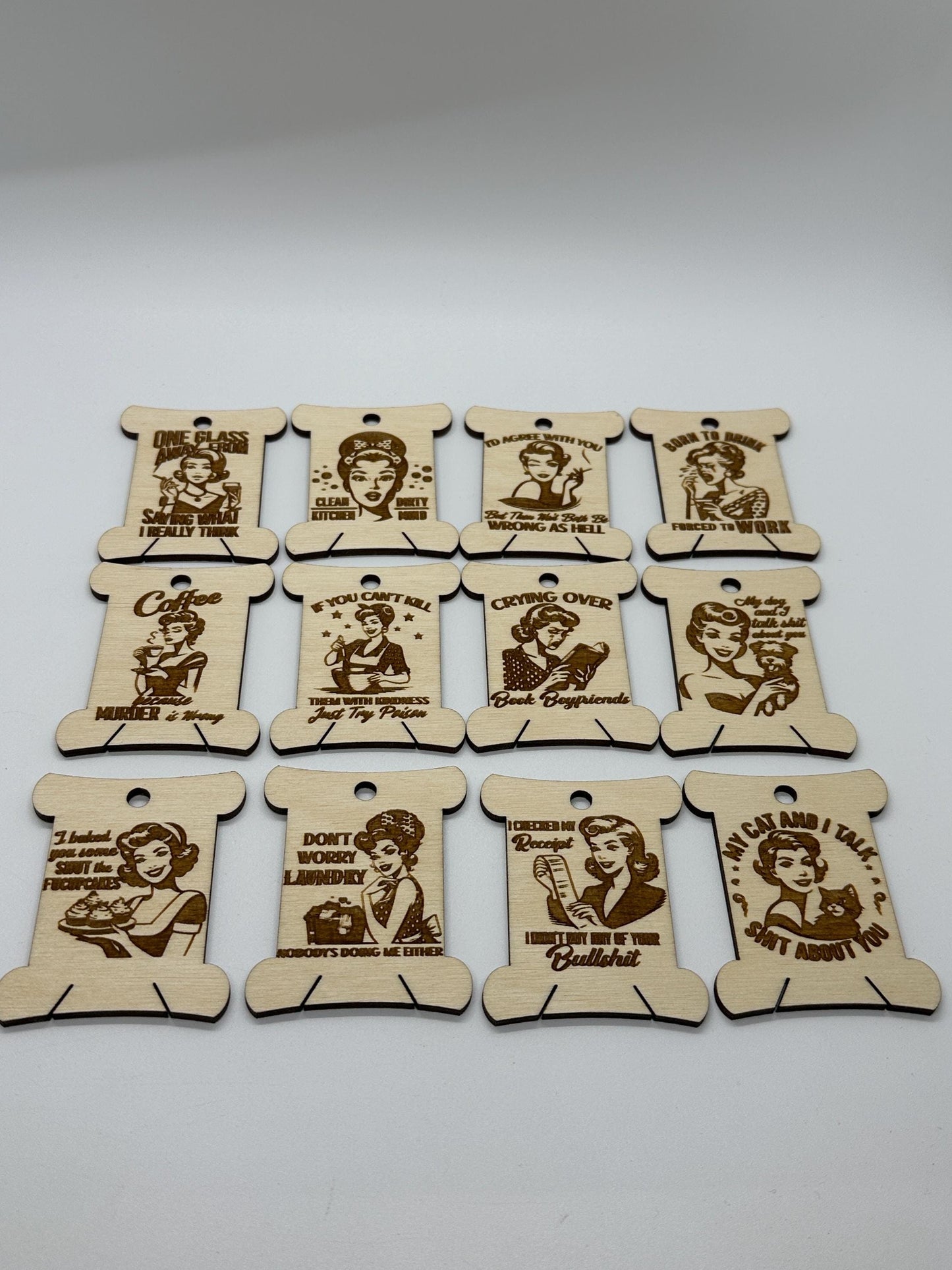 Set of wooden tags with engraved text and illustrations on a white background