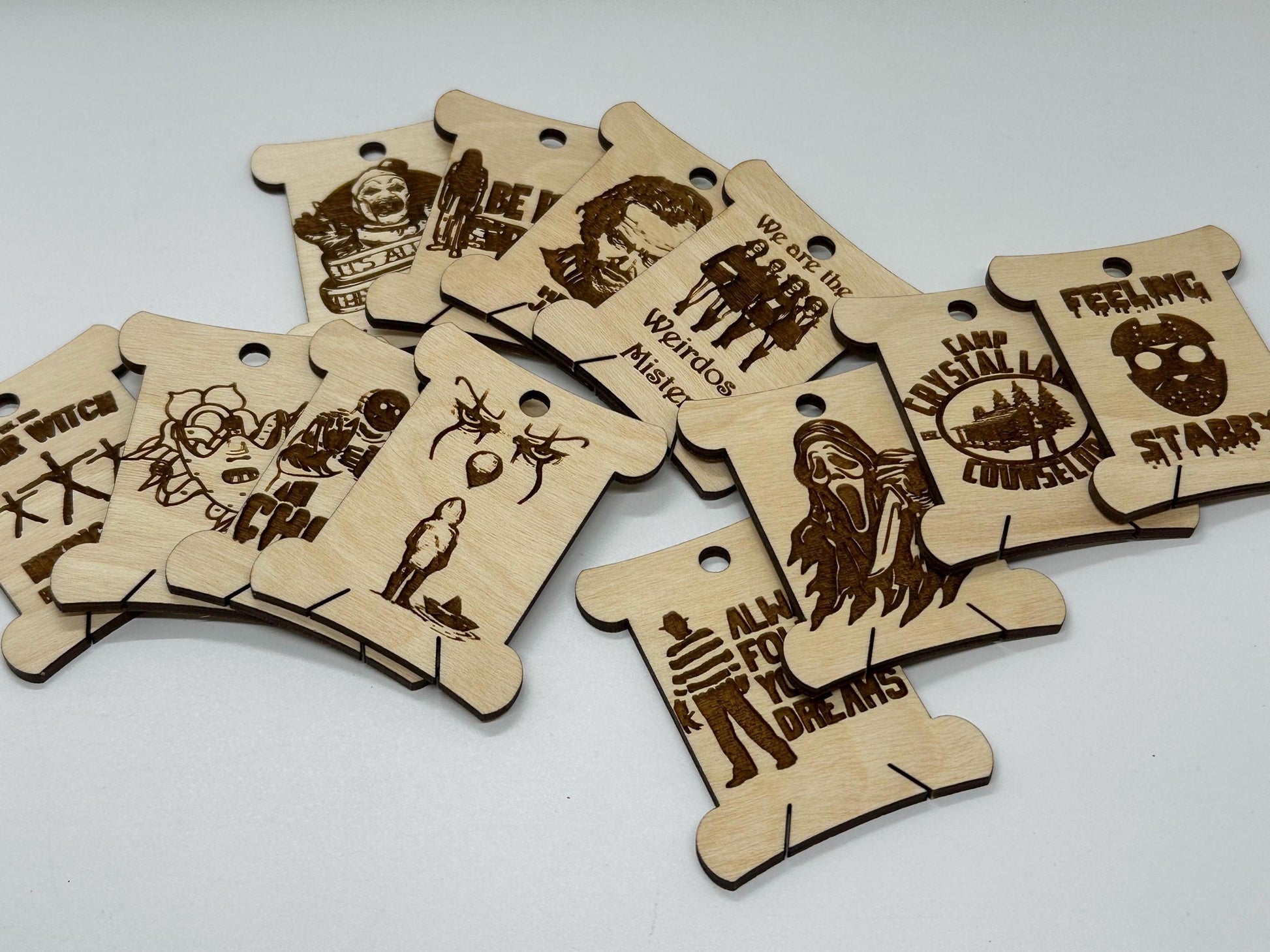 Wooden tags with laser-cut designs and text on a white background