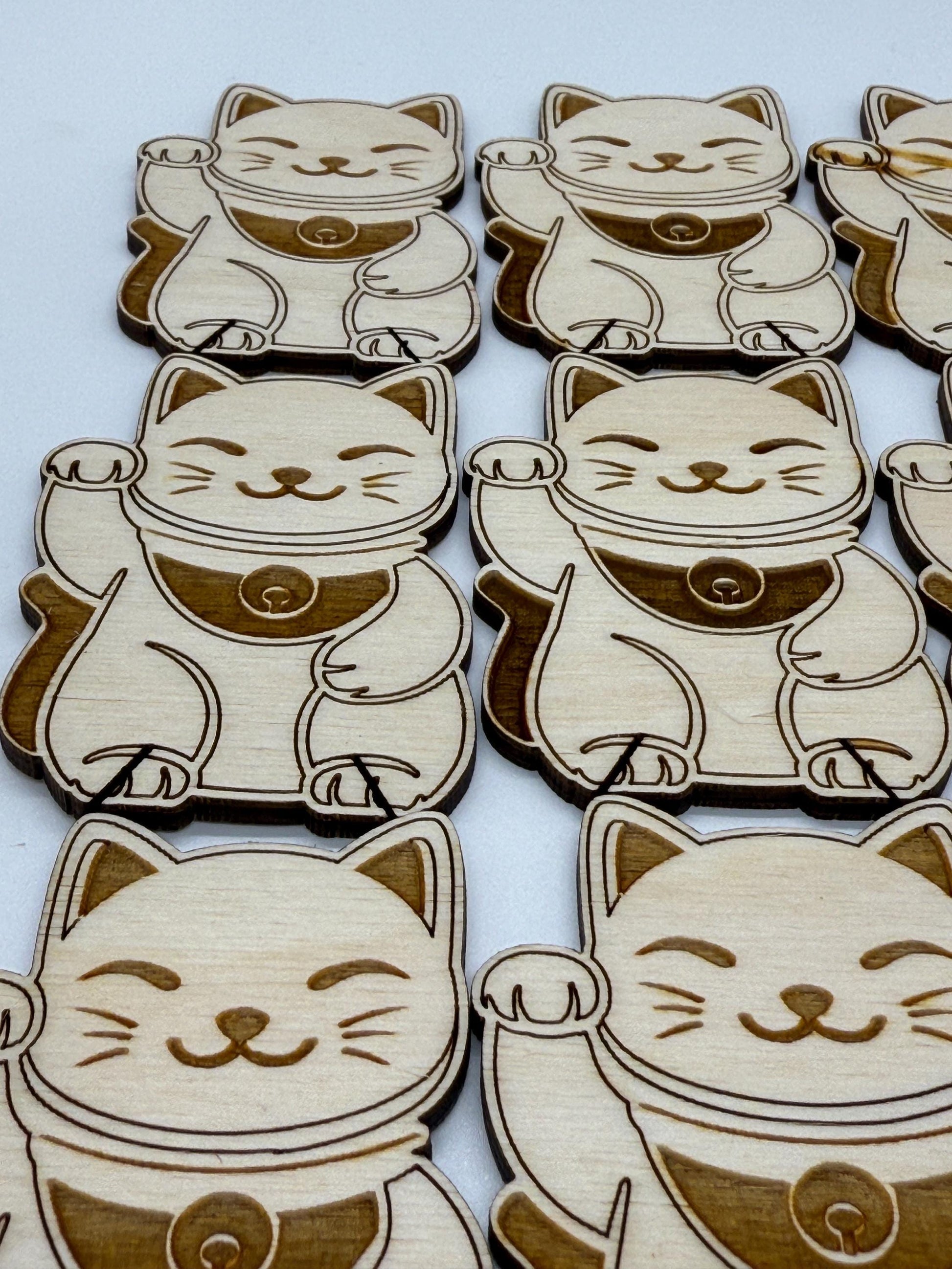 Wooden lucky cat figurines on a white background