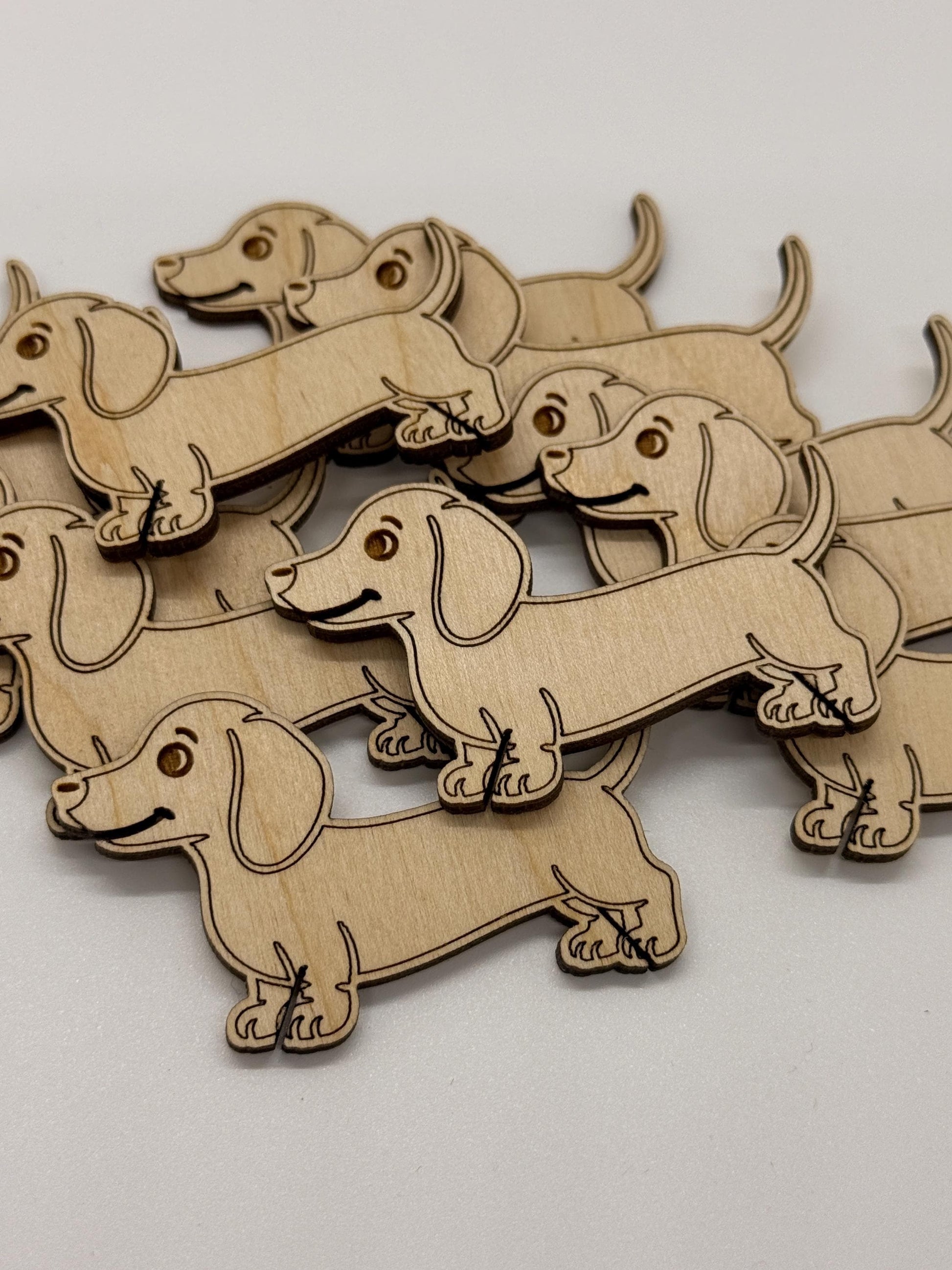 Wooden dachshund dog shapes on a light gray background