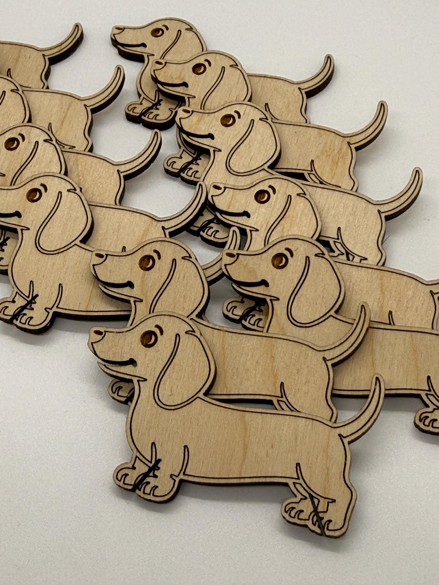 Wooden dachshund dog shapes on a light background