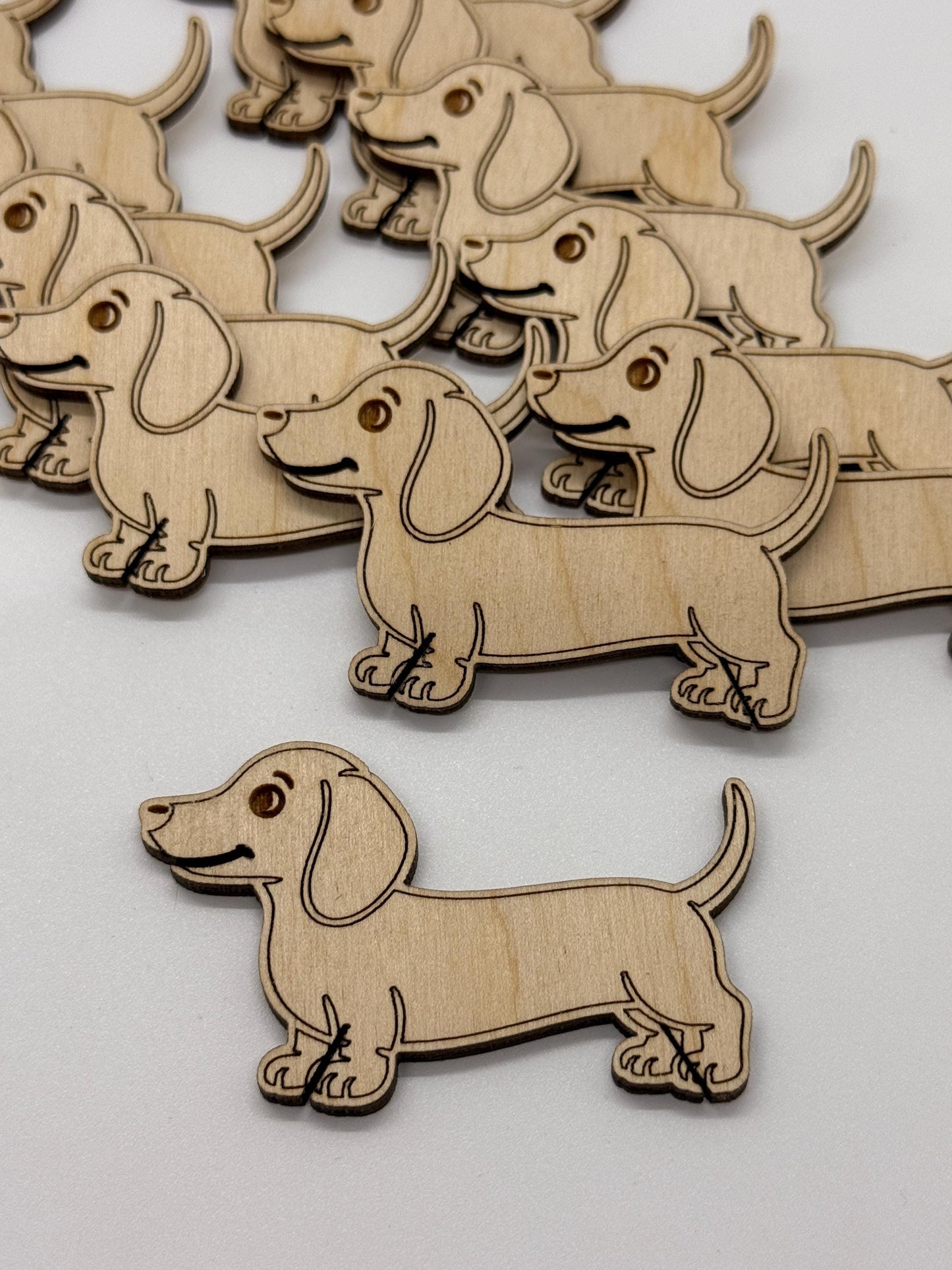 Wooden dachshund dog shapes on a white background