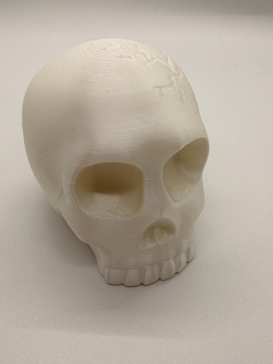 White skull-shaped object on a light gray background