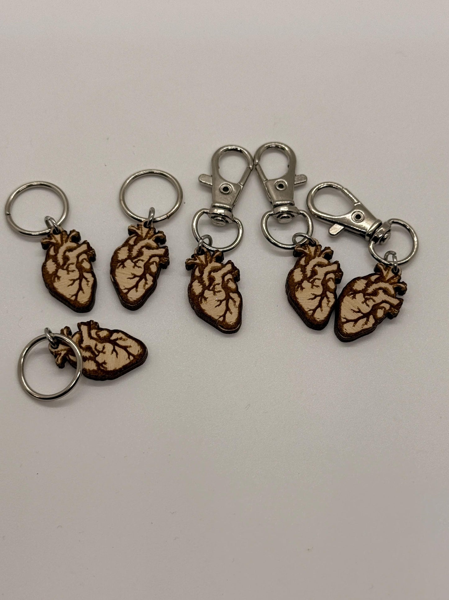 Set of anatomical heart keychains on a white background